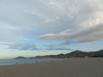 FZ007841 Sunset over mountains by beach.jpg